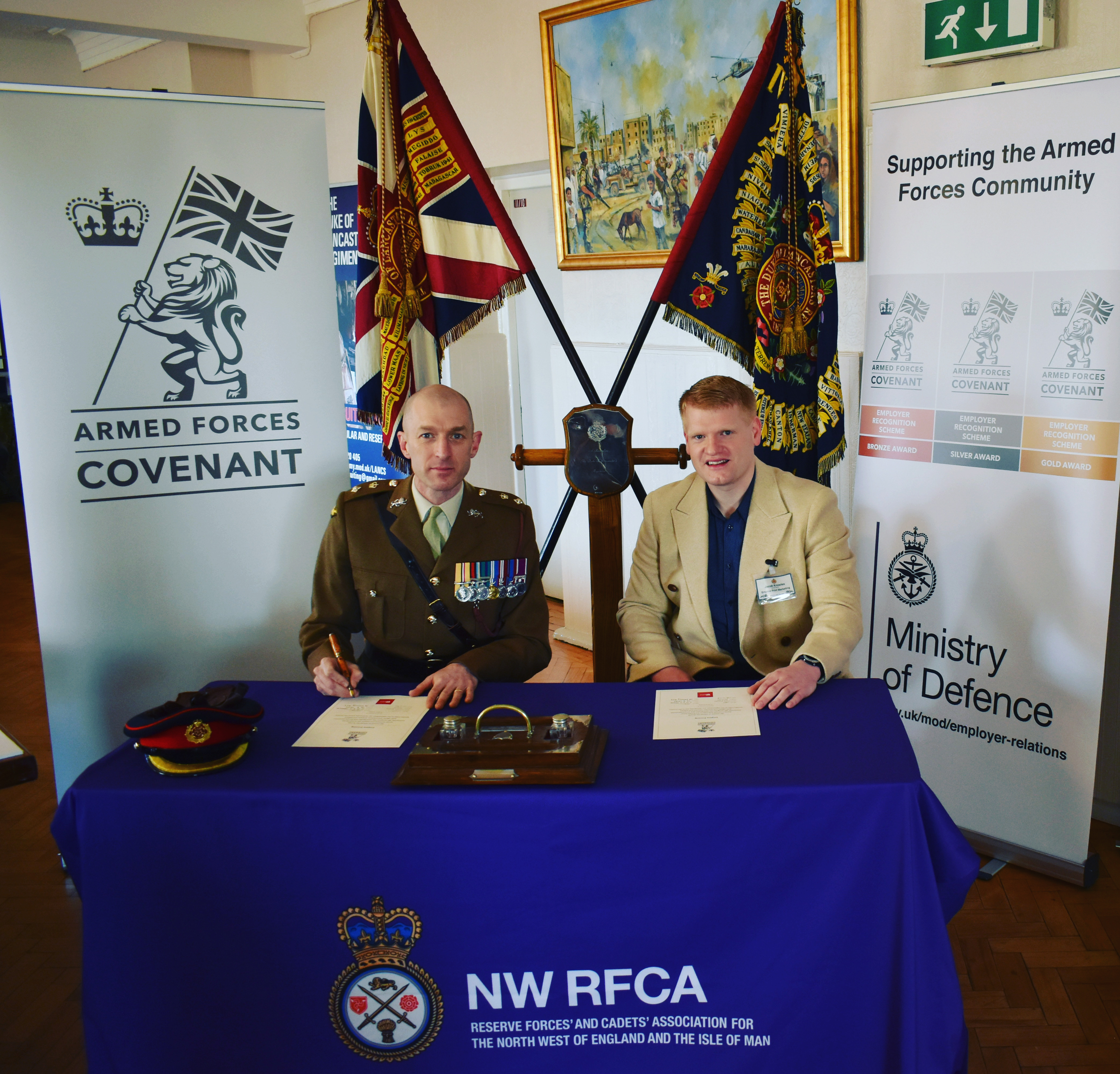 Jacob Knowles, Director, signing the Armed Forces Covenant